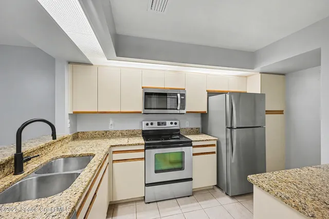 a kitchen with a refrigerator sink and stove