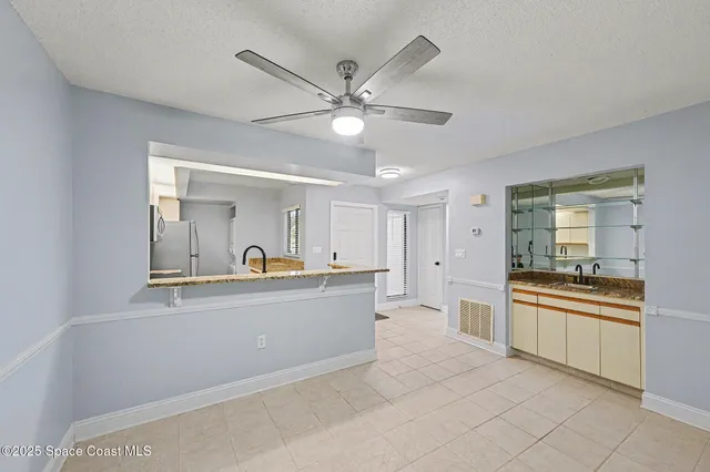 a view of a kitchen with a sink and cabinet