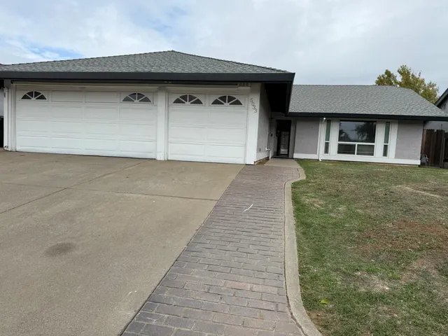 a front view of a house with garage