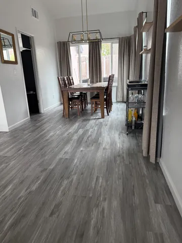 a view of a dining room with furniture window and wooden floor