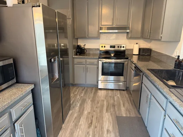 a kitchen with a sink stove and refrigerator