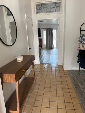 a living room with a table and a potted plant