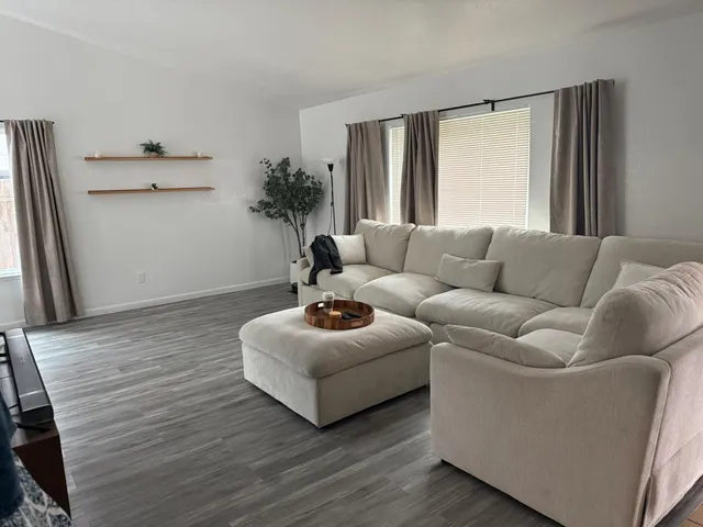 a living room with furniture and a large window