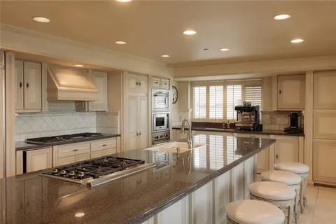 a large kitchen with stainless steel appliances granite countertop a lot of counter top space