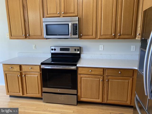 5128 Barness Court Doylestown, PA 18902 - Photo 12 of 27 a kitchen with granite countertop cabinets stainless steel appliances and wooden cabinets
