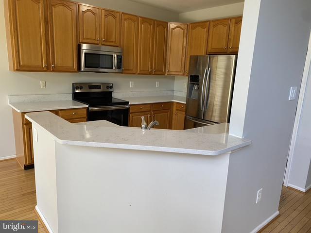 5128 Barness Court Doylestown, PA 18902 - Photo 13 of 27 a kitchen with stainless steel appliances a microwave a sink and a refrigerator