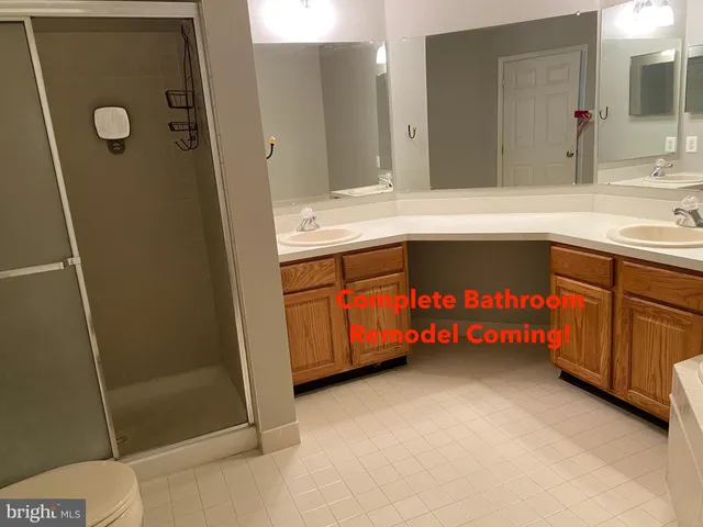 a spacious bathroom with a sink a mirror and a shower