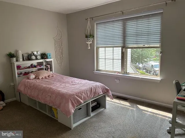 a bedroom with a bed and window