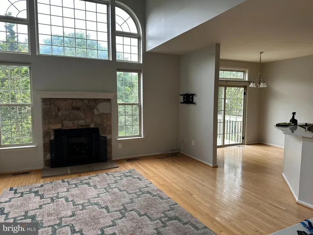 a view of empty room with a fireplace and windows