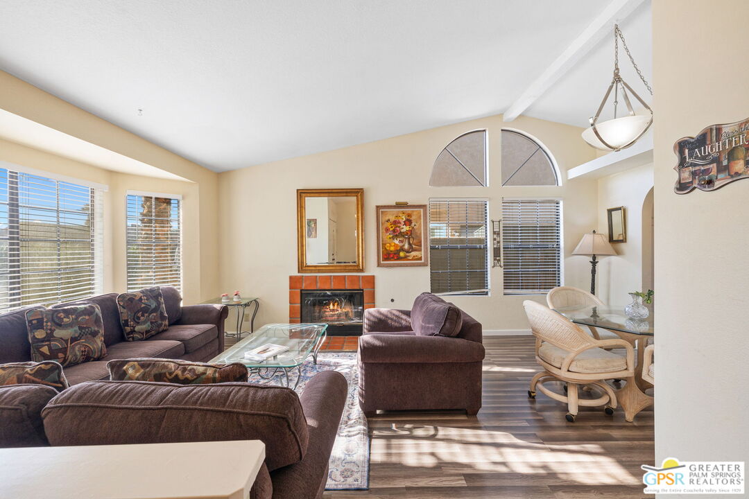 45688 Sutter Creek Road Indio, CA 92201 - Photo 8 of 51 a living room with furniture a large window and a chandelier
