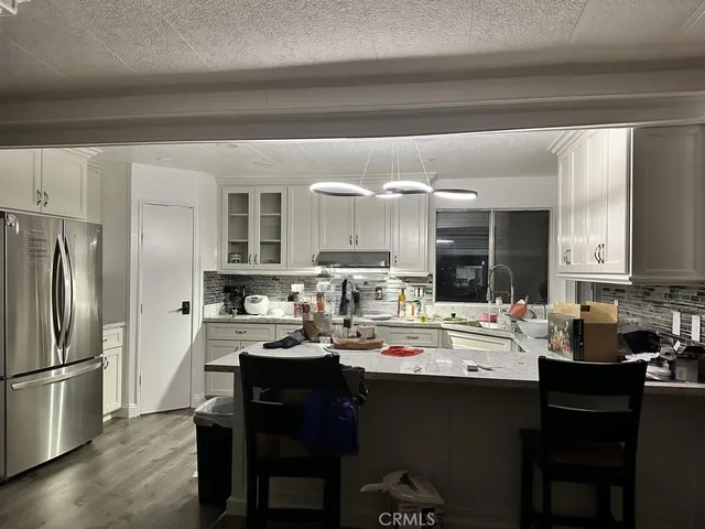 a kitchen with a sink appliances and cabinets