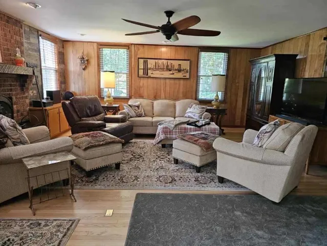 a living room with furniture ceiling fan and a window