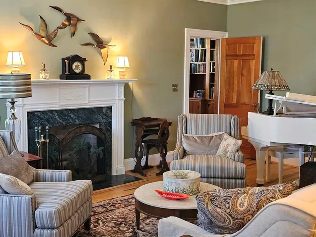 a living room with furniture and a fireplace