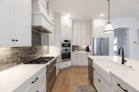 a kitchen with a sink stove and cabinets