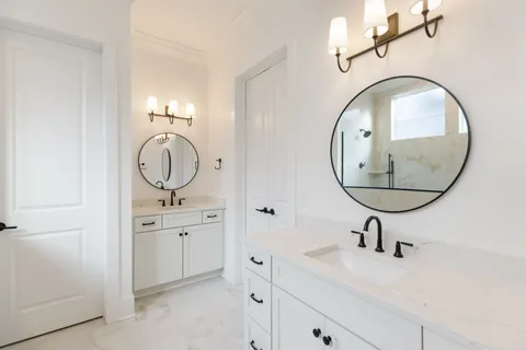 a bathroom with a sink a mirror a vanity and a mirror