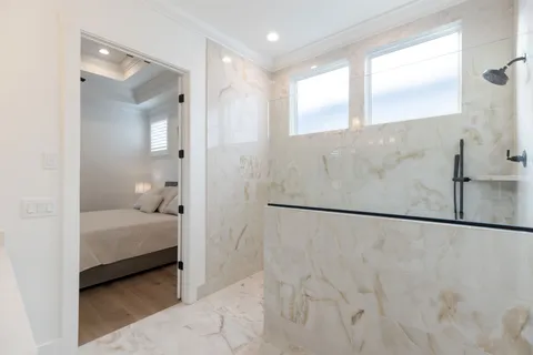 a bedroom with a bed and a painting on the wall