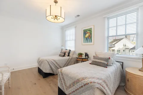 a bedroom with two beds and a window