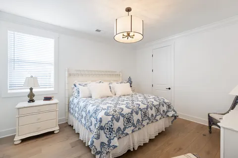 a bedroom with a bed and a chandelier