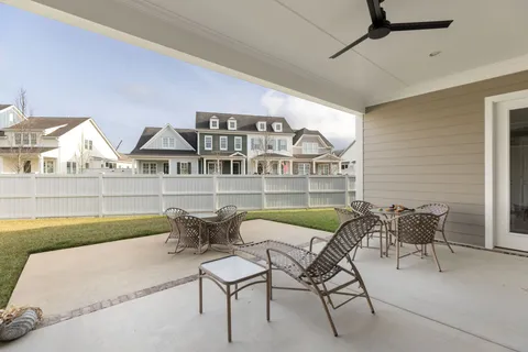 a balcony with table and chairs