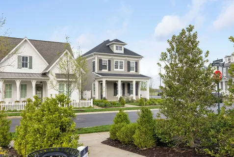 a front view of a residential houses with yard