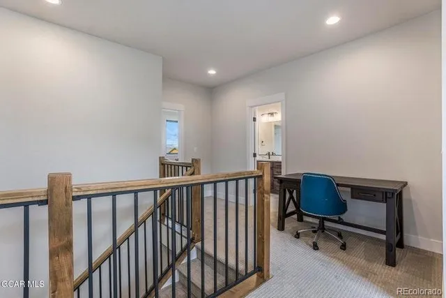 a view of hall way with furniture and stairs