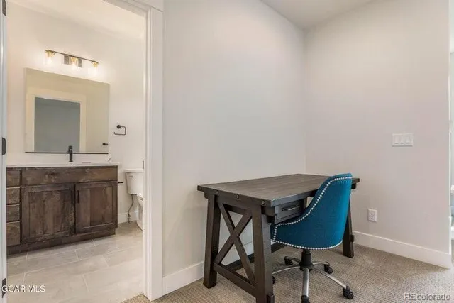 a room with a chair and a sink