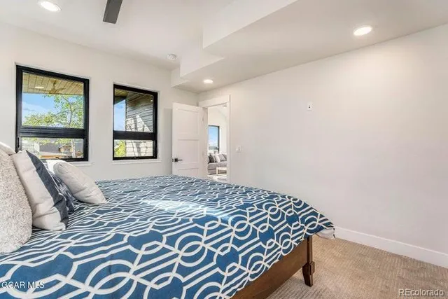 a bedroom with a bed and painting on the wall