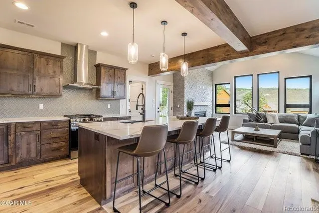 a large kitchen with a table and chairs