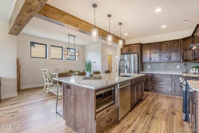 a kitchen with a sink stove and wooden cabinets