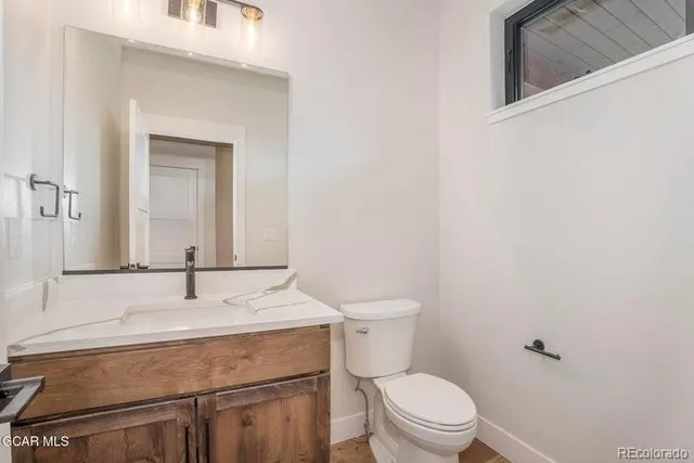 a bathroom with a sink toilet and mirror