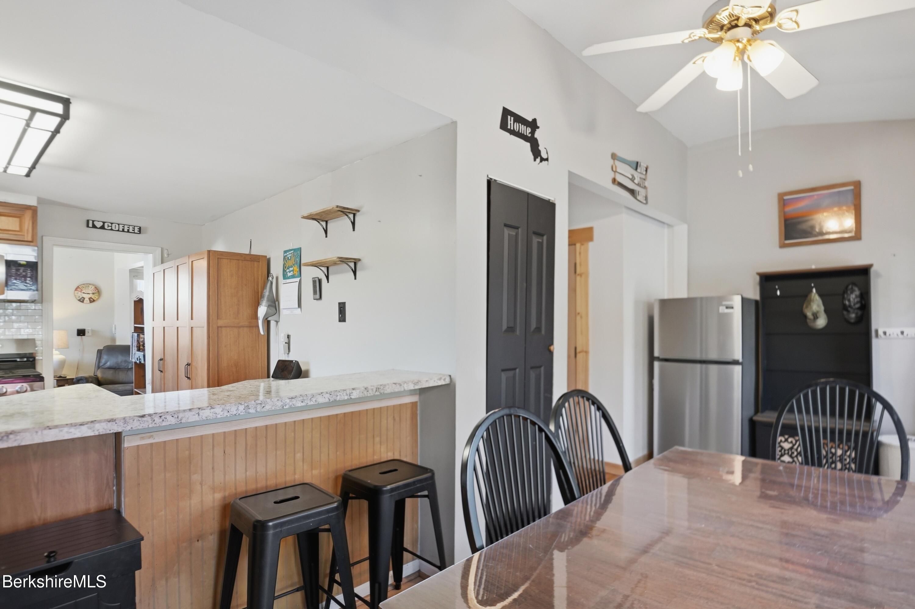 22 Broadway Street Pittsfield, MA 01201 - Photo 45 of 84 a kitchen with refrigerator and dining table