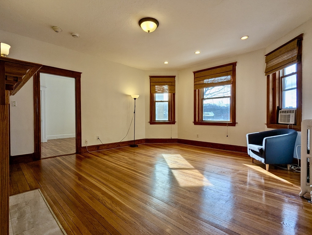 21 Westbourne Terrace, Unit 3 Brookline, MA 02446 - Photo 11 of 23 a view of an empty room with wooden floor and a window