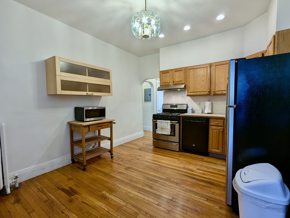 21 Westbourne Terrace, Unit 3 Brookline, MA 02446 - Photo 13 of 23 a kitchen with stainless steel appliances granite countertop a stove and a wooden floors