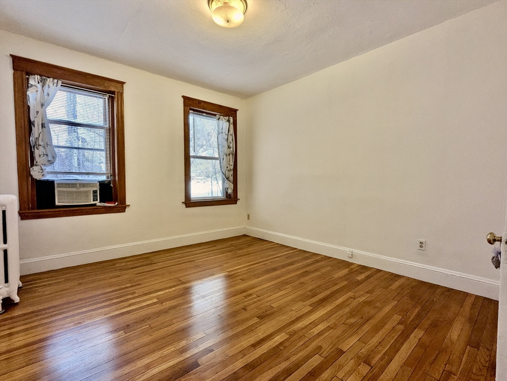21 Westbourne Terrace, Unit 3 Brookline, MA 02446 - Photo 20 of 23 wooden floor in an empty room with a window