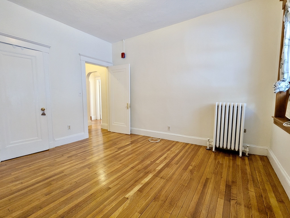 21 Westbourne Terrace, Unit 3 Brookline, MA 02446 - Photo 21 of 23 a view of empty room with wooden floor and fan