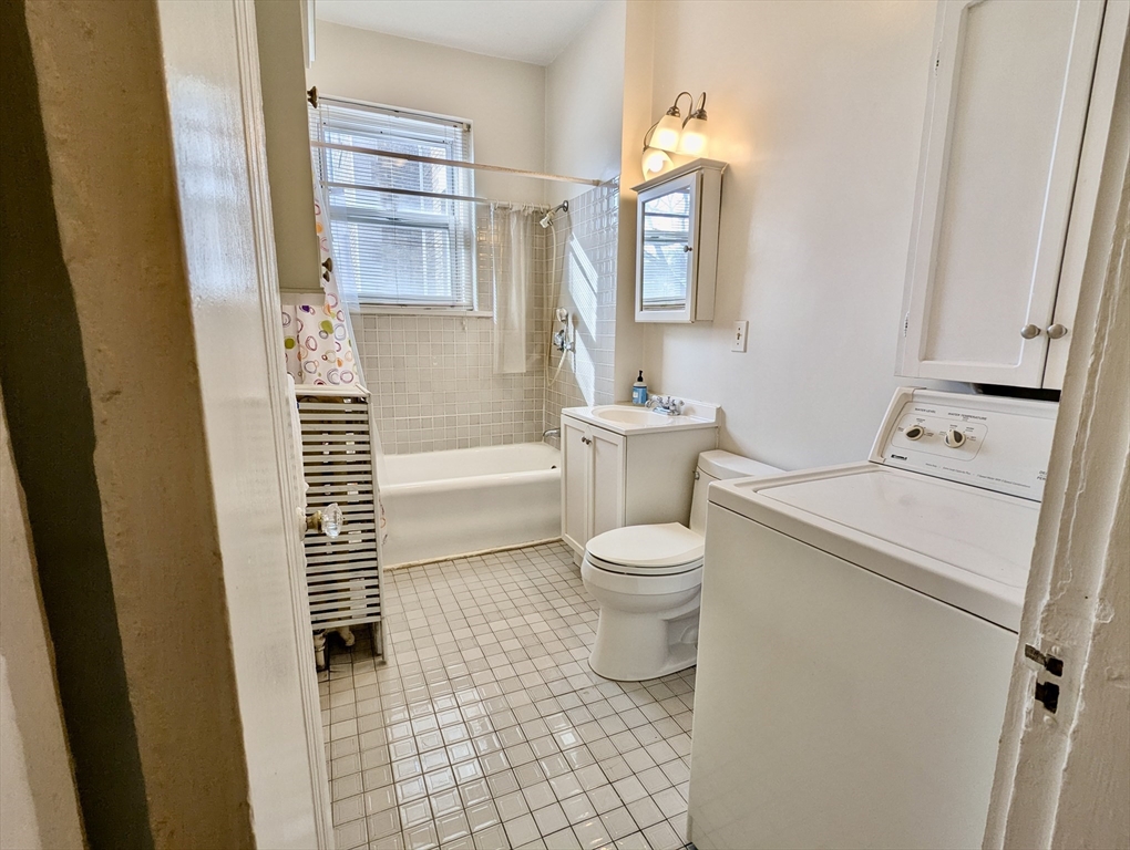 21 Westbourne Terrace, Unit 3 Brookline, MA 02446 - Photo 23 of 23 a white toilet sitting next to a bathroom sink