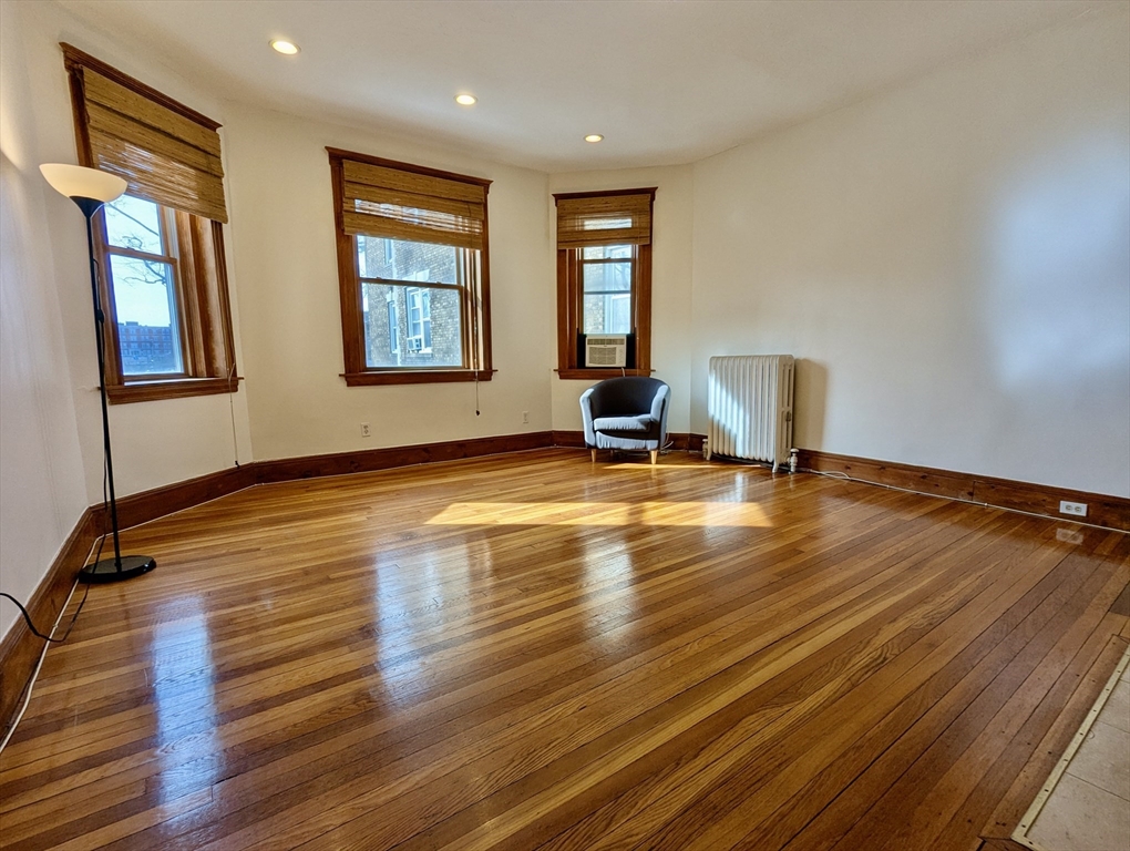 21 Westbourne Terrace, Unit 3 Brookline, MA 02446 - Photo 5 of 23 a view of an empty room with window and wooden floor