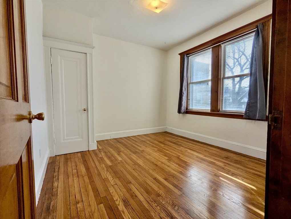 21 Westbourne Terrace, Unit 3 Brookline, MA 02446 - Photo 7 of 23 a view of empty room with wooden floor and fan