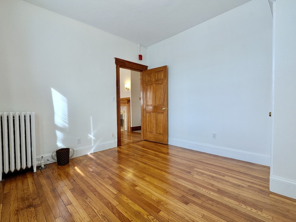 21 Westbourne Terrace, Unit 3 Brookline, MA 02446 - Photo 8 of 23 a view of an empty room with wooden floor