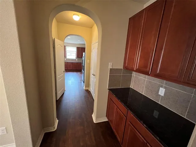 a view of a hallway view with wooden floor and staircase