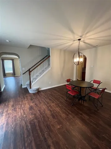 a living room with hard wood floors furniture and a wooden floor