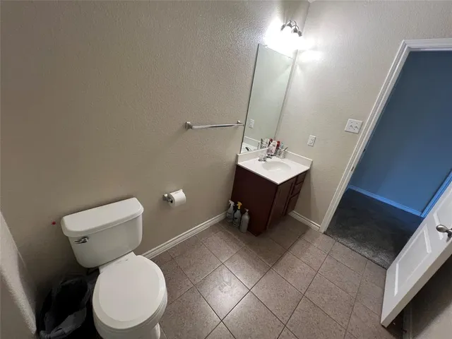a bathroom with a toilet a sink and mirror