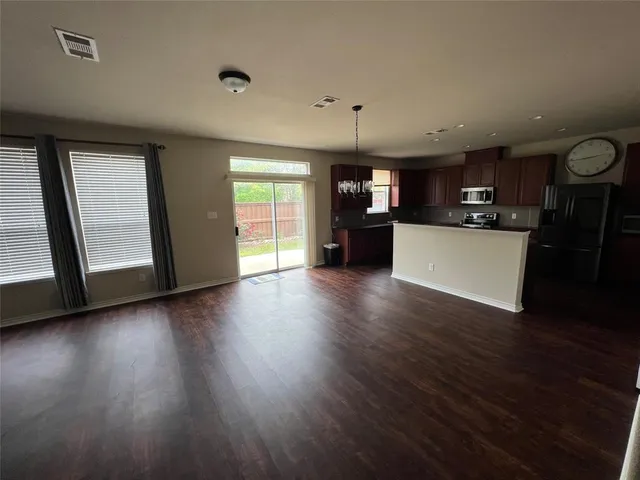 a view of a kitchen with a sink and a window