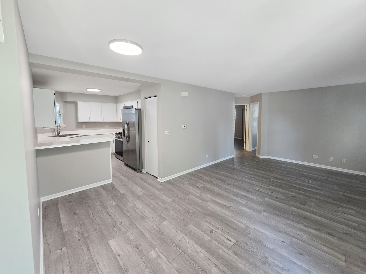 1349 Ridgefield Circle, Unit 1349 Carol Stream, IL 60188 - Photo 2 of 9 a view of a kitchen with a sink and a refrigerator