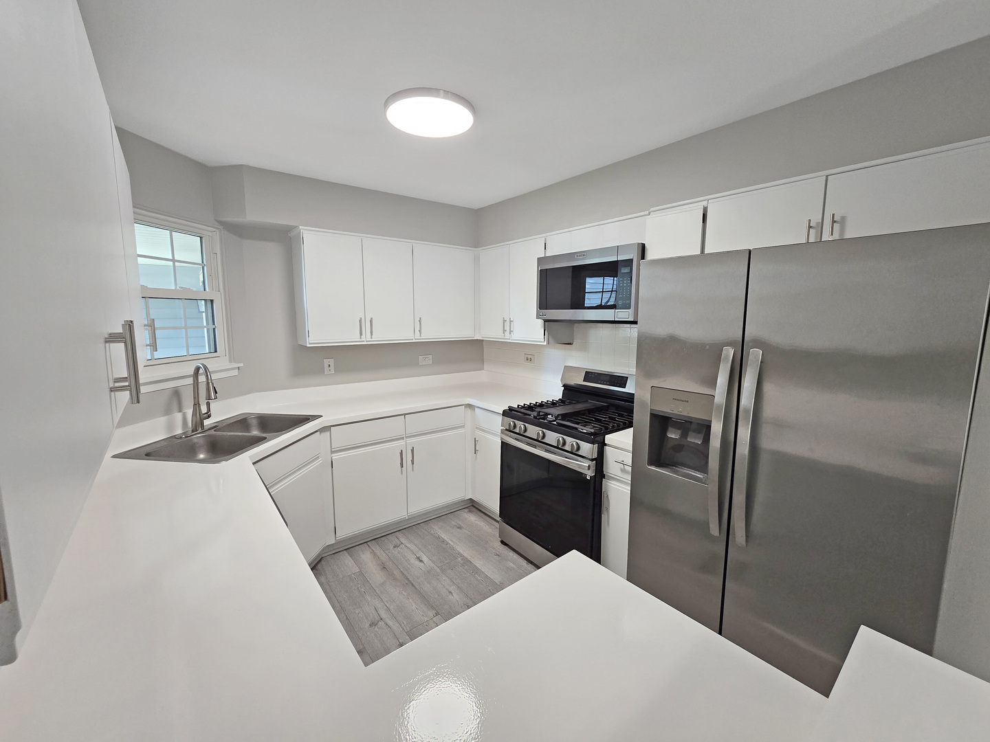 1349 Ridgefield Circle, Unit 1349 Carol Stream, IL 60188 - Photo 3 of 9 a kitchen with a refrigerator stove and sink