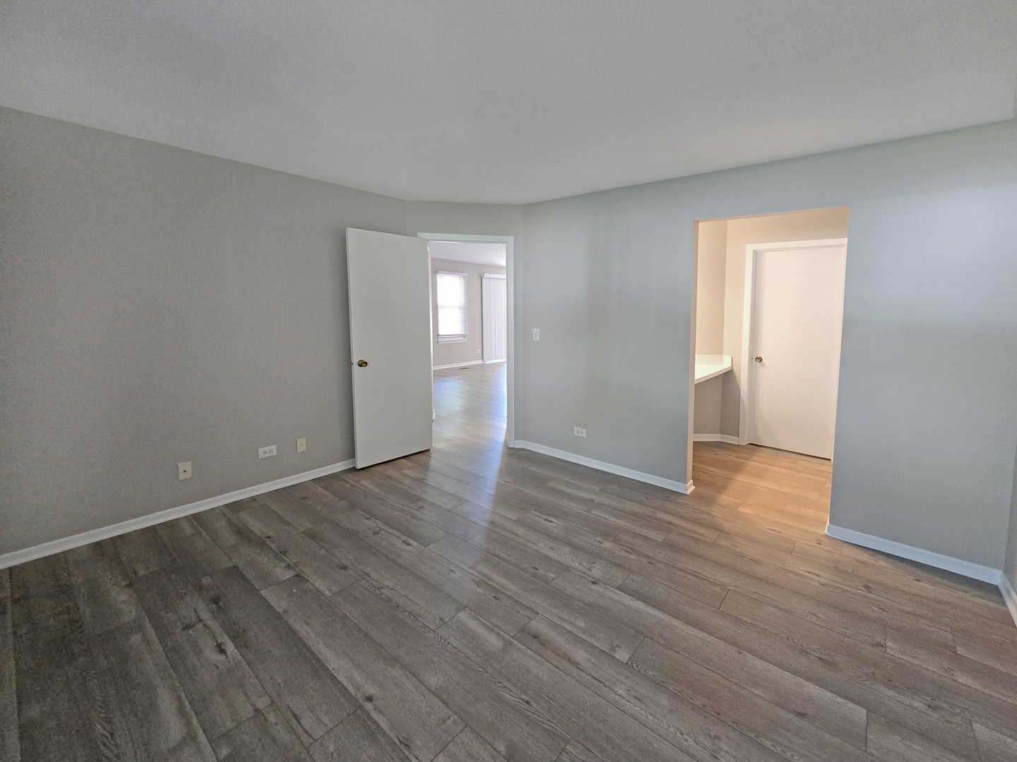 1349 Ridgefield Circle, Unit 1349 Carol Stream, IL 60188 - Photo 6 of 9 a view of an empty room with wooden floor and closet