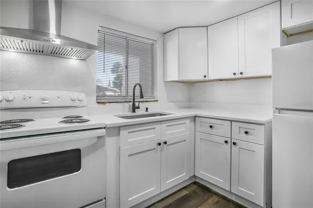 a kitchen with cabinets appliances and a sink
