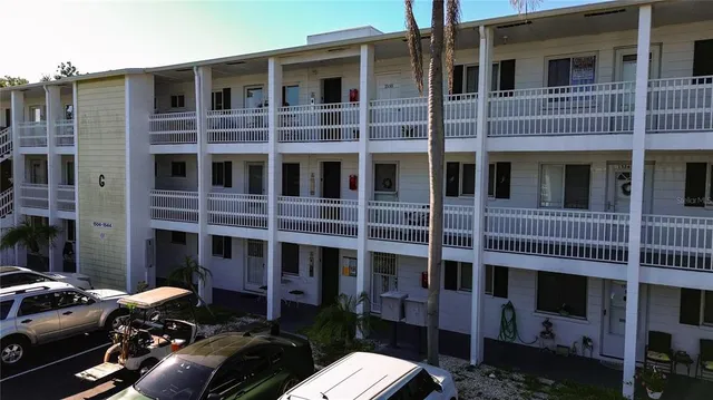 a couple of cars parked in front of a building
