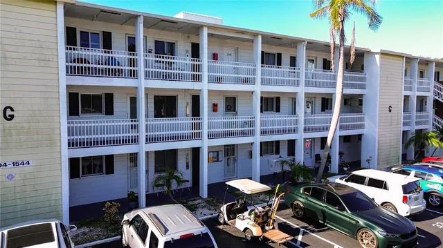 a front view of a building with outdoor seating