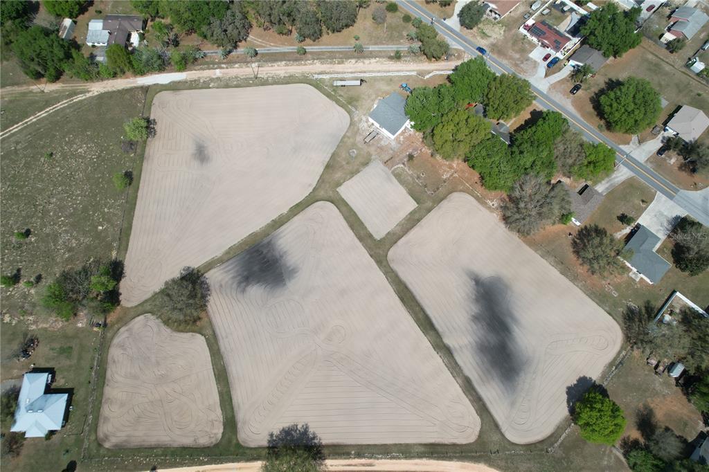 an aerial view of a house with a yard and a garage